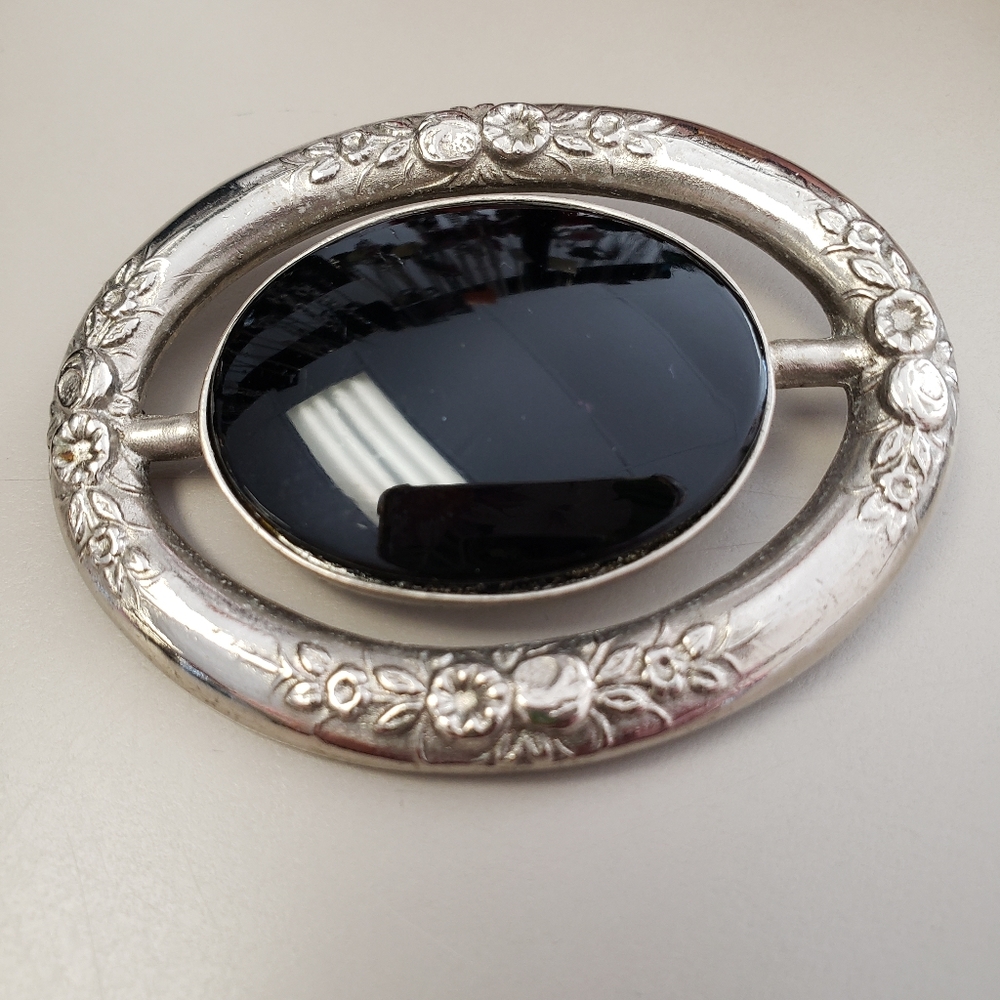 Silver with black brooch